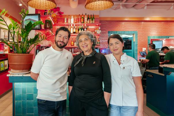 Three people standing side by side, posing for a photo