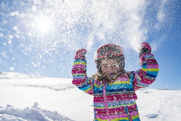 Little Girl Throwing Snow during a day of skiing at Deer Valley Resort