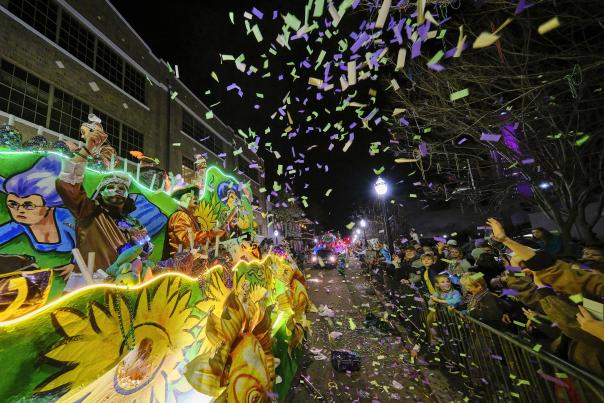 Mardi Gras float with confetti and crowd of people