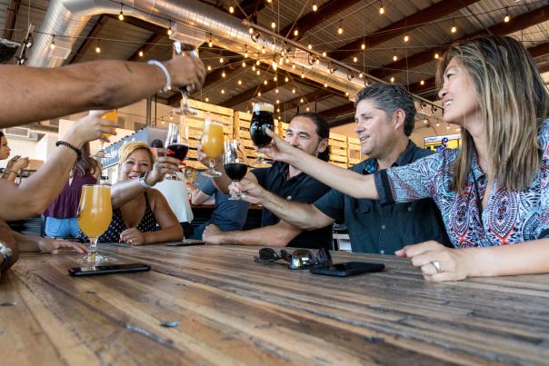 Group of five people enjoying a toast at The Sleepy Whale