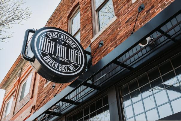 Signage outside High Kaliber Craft Kitchen displaying their logo