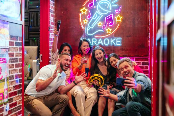 Group of friends singing karaoke at Seoul Pocha