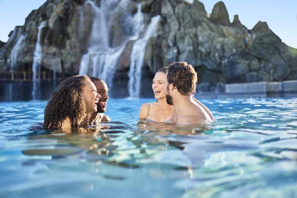 Two couples laughing in the water at Universal's Volcano Bay