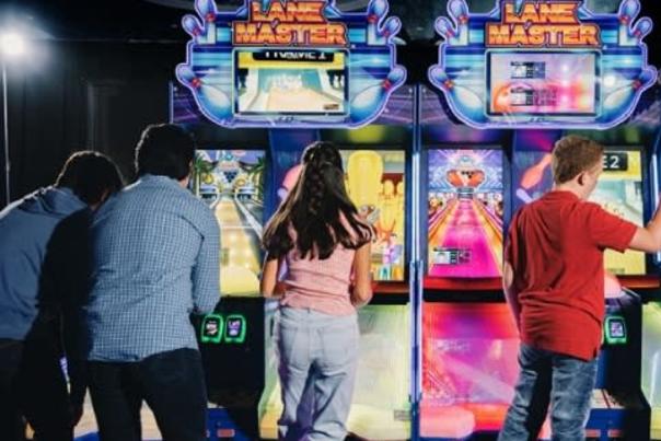 people playing arcade games