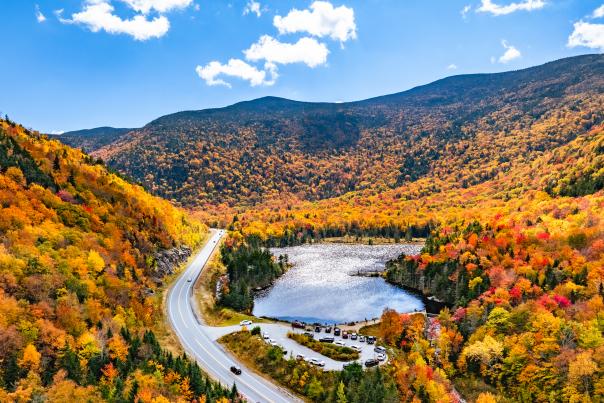 scenic pond with mountains covered in fall foliage