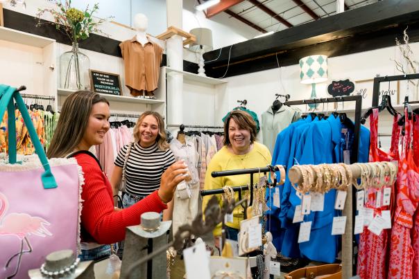 three ladies shopping in a boutique