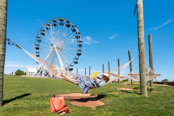 Woman reading in hammock at the Wheeler District Ferris Wheel