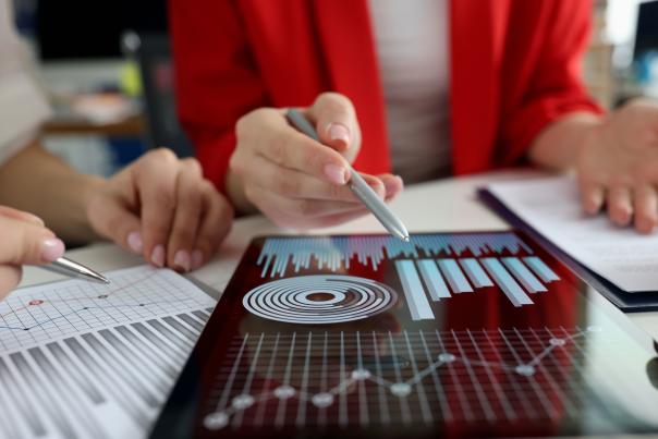 A tablet with a graph sits on a table