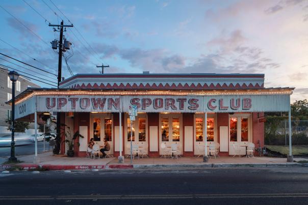 The exterior of Uptown Sports Club at dusk.