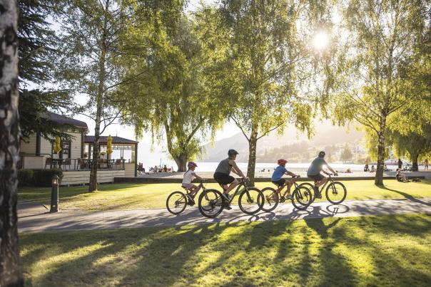 Family biking along Queenstown waterfront