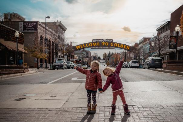 Children posing in front of Golden's Welcome Arch