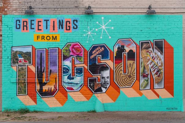 Colorful Mural on brick wall that reads "Greetings from Tucson"