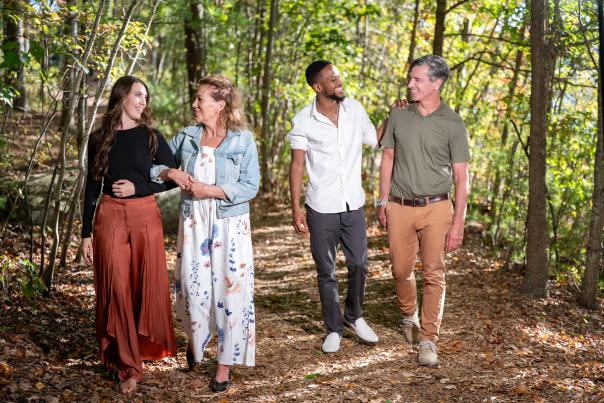 Two women and two men take a walk down a forest path in the Pocono Mountains.