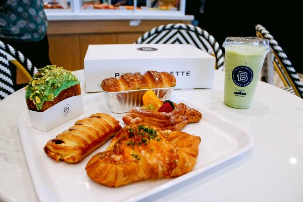 A tray full of pastries and an iced matcha latte from Paris Baguette