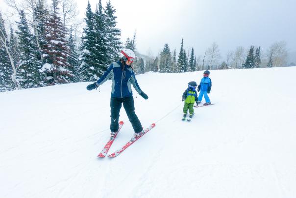 Mother Skiing with her two young kids
