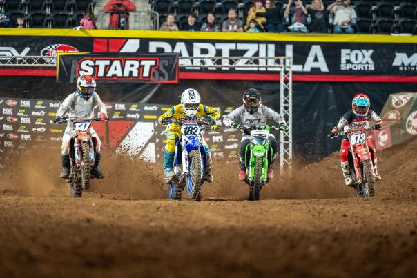four arena dirt bike racers
