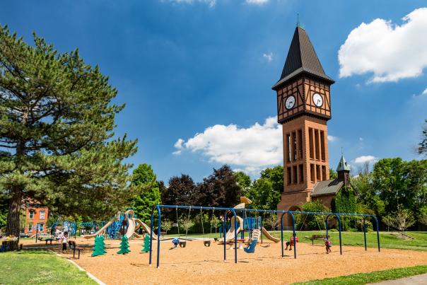 Image is of Goebel Park with the clock tower in the back and playground in the foreground.