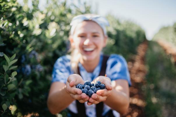 girl holding blueberries