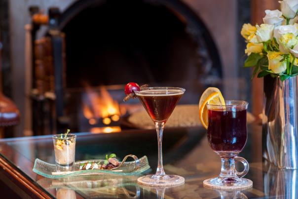 Two festive drinks and dessert by the fire at Summer Lodge Country House Hotel