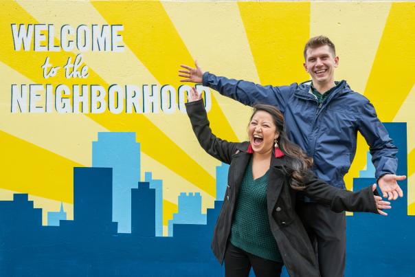 Couple enjoys the Welcome to the Neighborhood mural in the Vista Greenway.