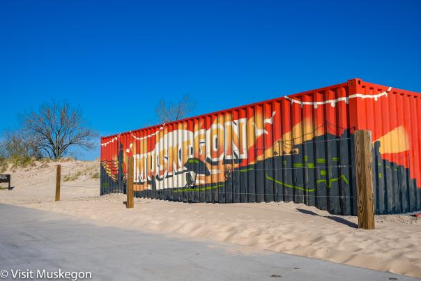 muskegon mural painted on shipping container serving as stage on beach