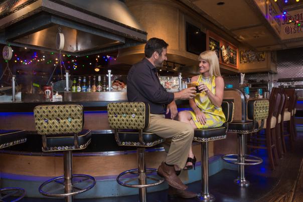 A couple clinks glasses at Ameristar Pearl's Oyster Bar in St. Charles, MO.