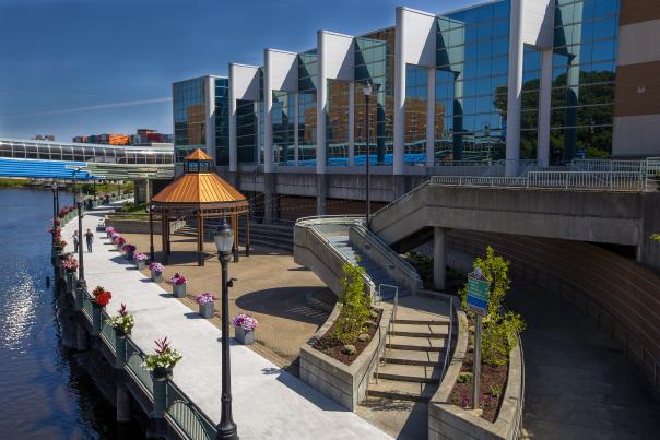 People walking on the Lansing River Trail by the outdoor space at the Lansing Center