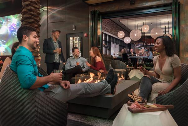 Chroma Modern Bar + Kitchen guests relaxing by firepit