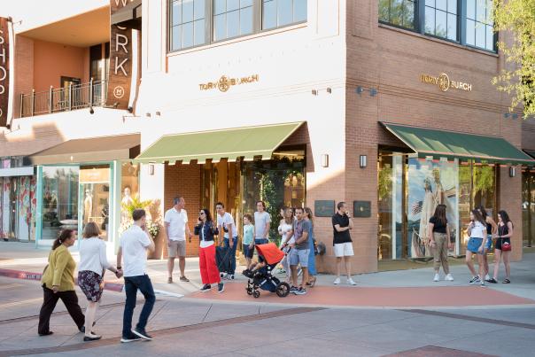 Shoppers crossing the street in front of Tory Burch at Market Street
