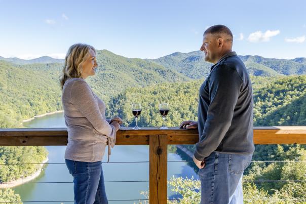 Couple on Deck Overlooking Lake