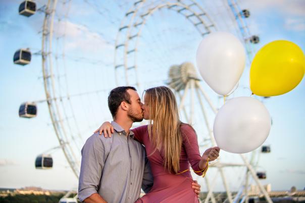 Couple kissing in front of ICON Orlando.