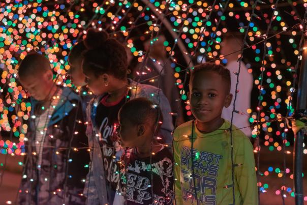 kids looking through a Christmas light display