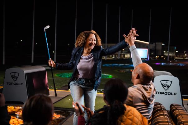 Woman high-five at Topgolf