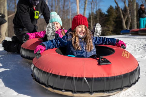 Two little girls prepare for some fun snow tubing in the Poconos!