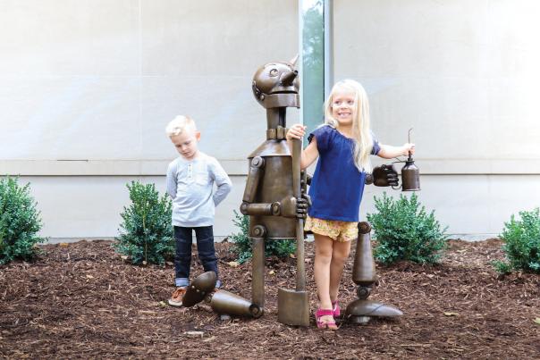 Children climbing on Bronze statue of the Tin Man