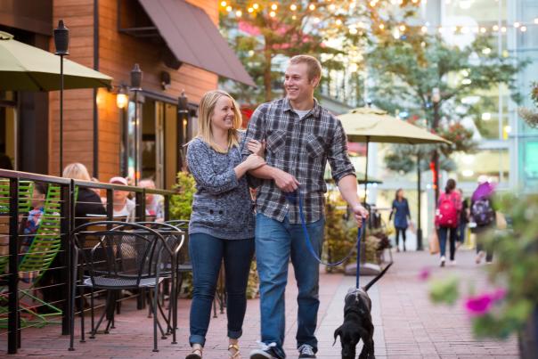 Man, woman and dog walking in University District in the fall