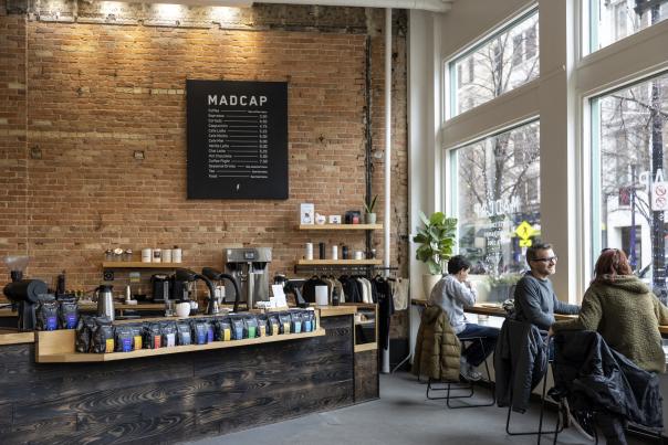 Interior picture of Mascap showcasing its menu while customers enjoy a beverage.