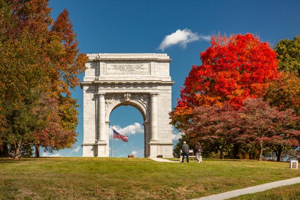 Valley Forge National Historical Park in King of Prussia with fall foliage filled trees standing around the iconic arch.