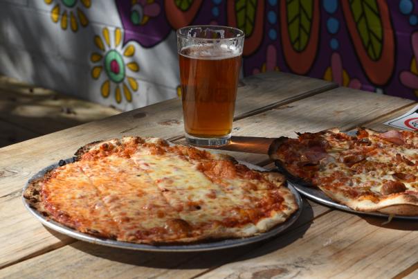 pizza and beer on a patio table