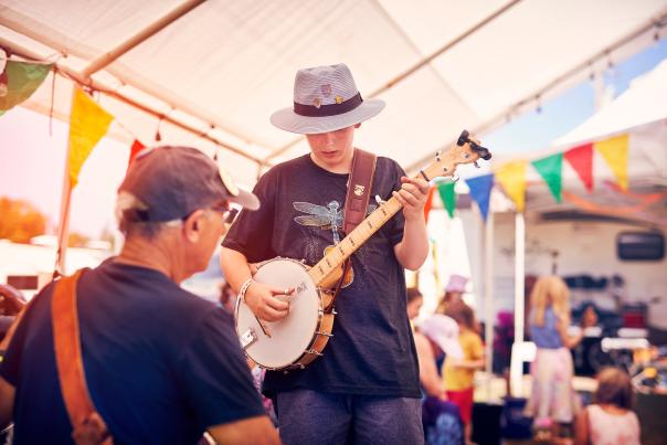Two men play instruments at walnut valley festival