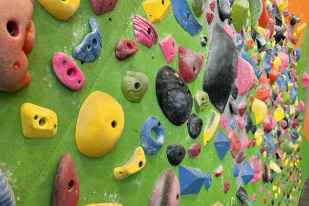 Colorful indoor bouldering wall at a rock climbing gym in Bentonville, AR.