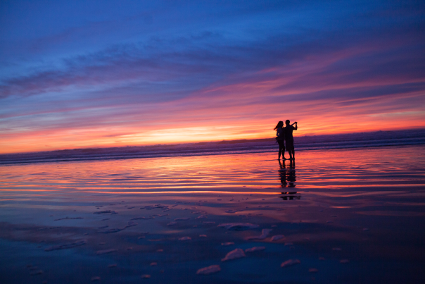 couple dancing on beach at sunset