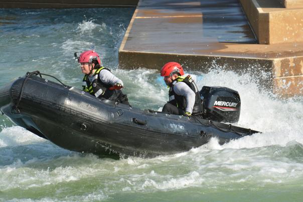 Two people participating in the Swiftwater Championship Games via raft