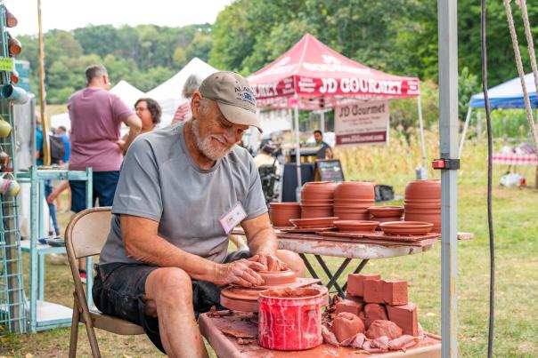 A man creates handmade pottery at the Pocono State Craft Fair.