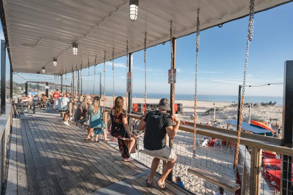 Swings on deck over looking lake Michigan and sand