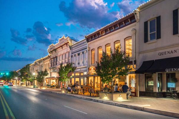 Image of Georgetown, Texas main street at dusk illuminated by string lights.