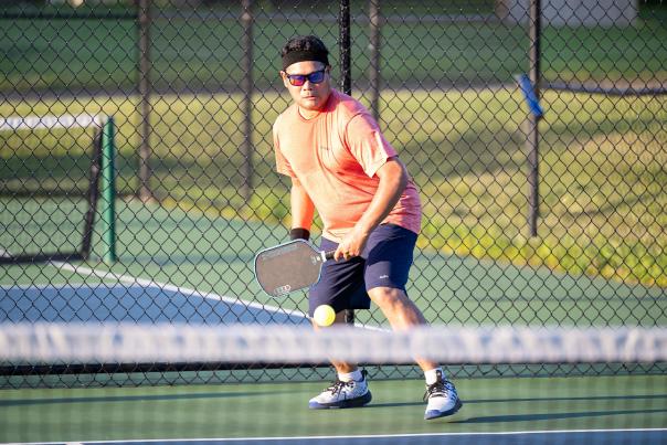 Pickleball player at Pioneer Park in Woodbury during a warm day.