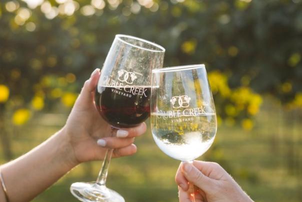 Two wine glasses from Cauble Creek Vineyard "cheersing"