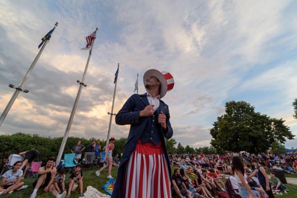 A man, dressed as Uncle Sam, at a Fourth of July celebration in Kettering, Ohio, surrounded by other people.