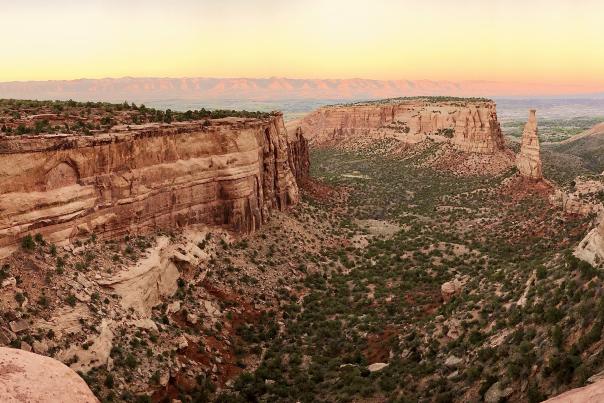 View of Colorado National Monument at Sunset with Book Cliffs in Background